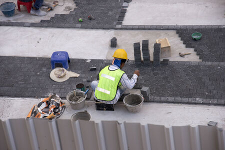 Workman laying block pavingのeditorial素材
