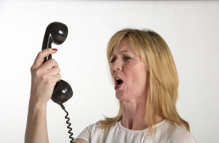 Angry woman shouting into a telephone
