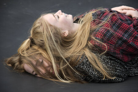 Teenagers playing laying on each otherの写真素材