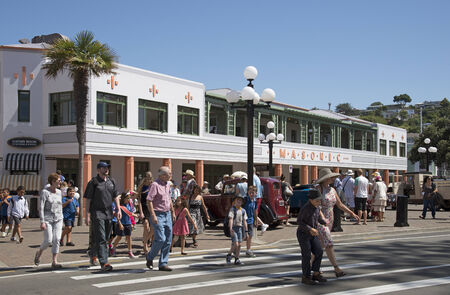 Visitos to the Art Deco weekend crossing street outside the Masonic Hotel Napier New Zealandのeditorial素材