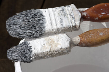 Professionals paint brushes on the edge of a painters kettleの写真素材