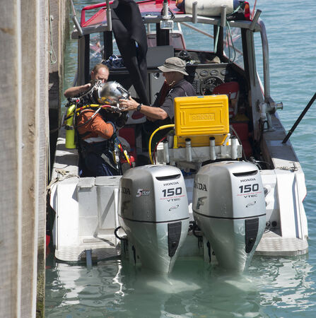 Commercial diver removing helmet in Napier Port New Zealand