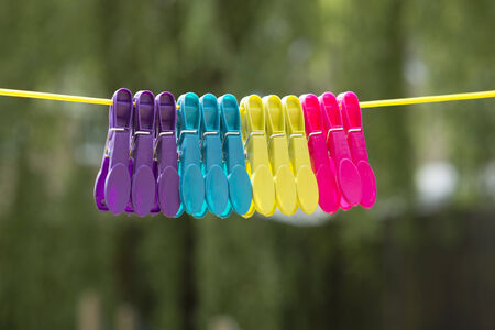 Plastic pegs hanging on a washing line