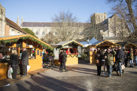 Visitors at the Christmas Market in The Close at Winchester Cathedral Hampshire England UK 13 December 2014のeditorial素材