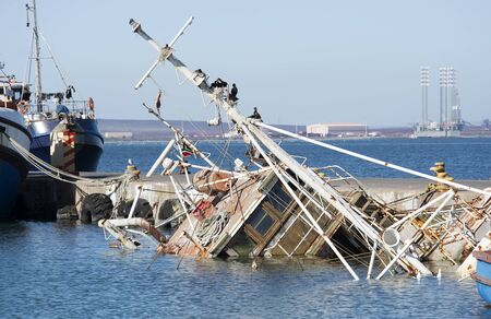 Danger to shipping a sunken fishing boatの写真素材