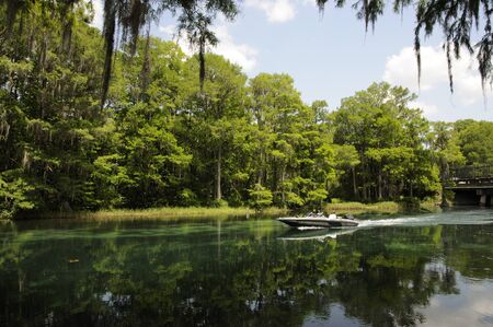 Javelin powerboat cruising on the Rainbow River at Dunnellon in Marion County Florida USAのeditorial素材