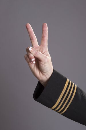Airline officer making a gesture with her hand V signの写真素材