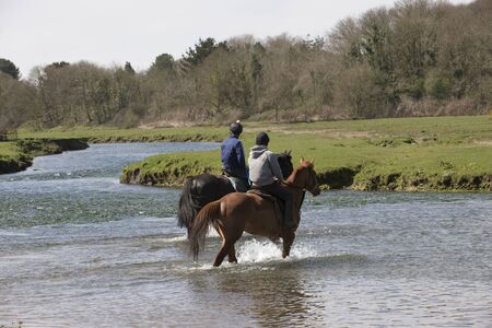 Horse riders on the Ogmore River in South Wales UKのeditorial素材