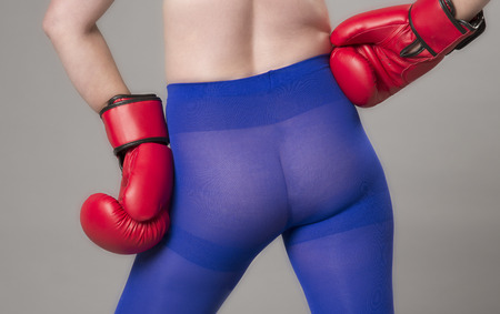 Female boxer wearing red boxing gloves and blue tightsの写真素材