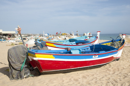 Colorful fishing boats on the fisherman's beach at Armacao de Pera Portugalのeditorial素材