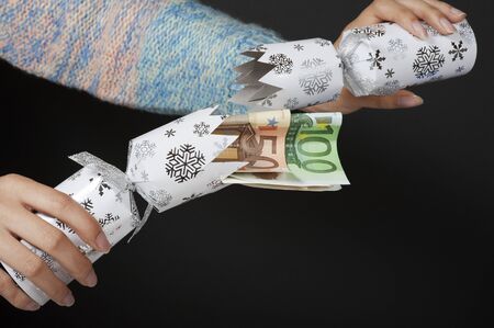 Christmas cracker and Euro banknotes insideの写真素材