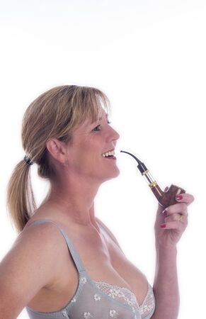 Mature woman smoking an electronic pipeの写真素材