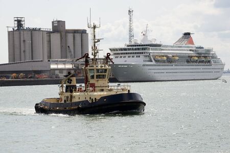 Tug and cruise ship in portのeditorial素材