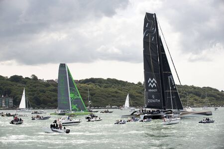 Yachts Phfedo 3 and Genes X Mirabaud 1819 Zenith looking for some wind at the start of the Rolex Fastnet Race on the Solent off Cowes today. Picture Peter TitmussAlamy Sunday 16 August 2015のeditorial素材