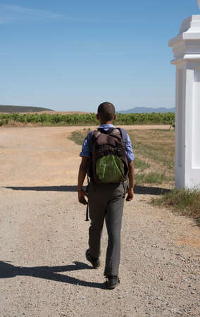 Schoolboy walking to school along an African highwayのeditorial素材
