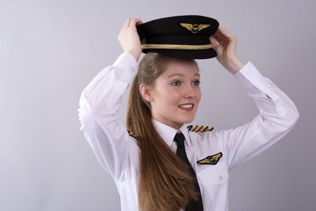 Young female airline pilot in uniform
