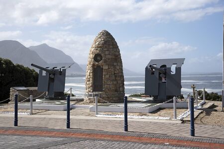 HERMANUS WESTERN CAPE SOUTH AFRICA - APRIL 2016 - The War Memorial on the seafront in Hermanus and two naval guns which face inward towards the town. The guns point in this direction as we are not at war.のeditorial素材