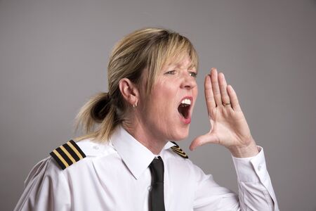 OFFICER SHOUTS AN ORDER MAY 2016 - Portrait of a female uniformed officer shouting and orderの写真素材