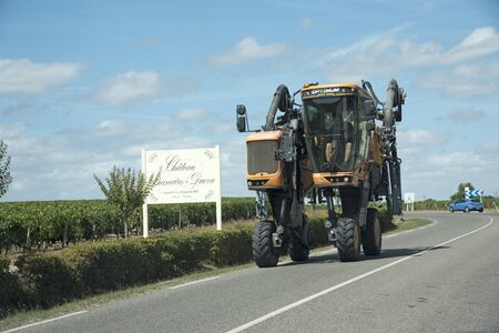 A Straddle tractor with spraying equipment on a public road. Saint Julian in the Medoc region of Franceのeditorial素材
