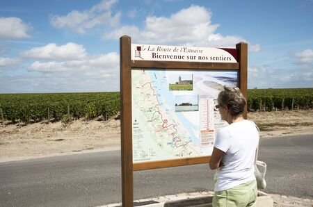Gironde region France - August 2016 - A tourist reading a tourism information board in the Gironde region of Bordeaux Franceのeditorial素材