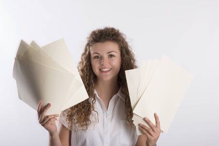 Smiling woman holding paper filesの写真素材