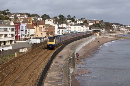 A First Great Western company passenger train passing through Dawlish a seaside resort in south...