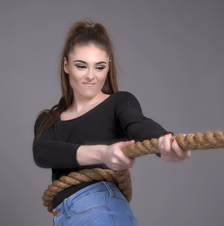 Young girl pulling on a rope