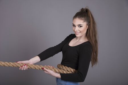 Young girl pulling on a rope