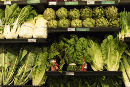 Vegetables and salad produce on a supermarket shelfのeditorial素材