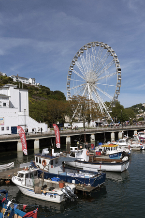Fishing boats on the Torquay seafront and big wheel loking towards Beacon Quay.Torquay Devon England UK May 2017のeditorial素材