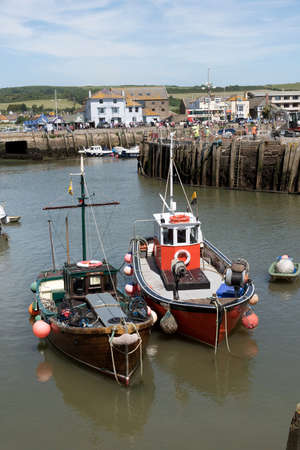 The harbor at West Bay on the Jurassic coast in West Dorset England UK. June 2017. Two commercial fishing boats in the harbourのeditorial素材