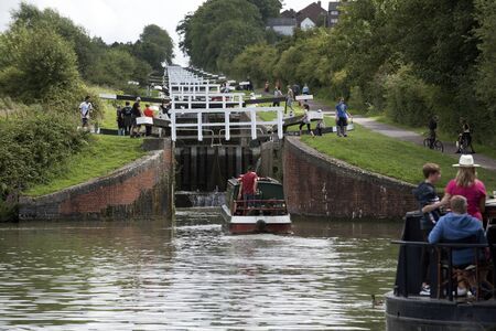 Narrowboat entering the lower lock of the Caen Flight of Locks on the Kennet & Avon Canal in Devizes Wiltshire UKのeditorial素材