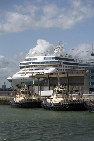 Port of Southampton England UK. The administration offices, tugs and a cruise liner, Norwegian Jade alongsideのeditorial素材