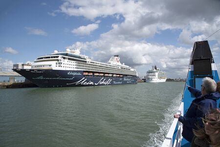 Cruise ship Mein Schiffi 1 on a stopover in the Port of Southampton England UK. August 2017. Tourists viewing from a tour boat.のeditorial素材