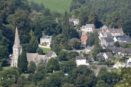 An overview of Woodchester and St Marys Church from Amberley Gloucestershire England UK over the Nailsworth Valleyのeditorial素材