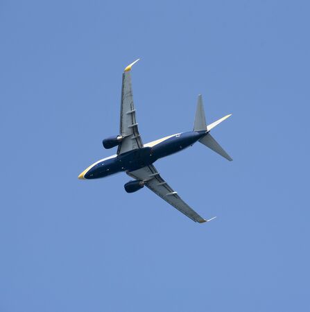 Underside of a twinjet taking off against a blue sky