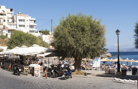 Agios Nikolaos, Crete, Greece, Tourists on the Kitroplatia municipal beach close to the town centre. October 2017のeditorial素材