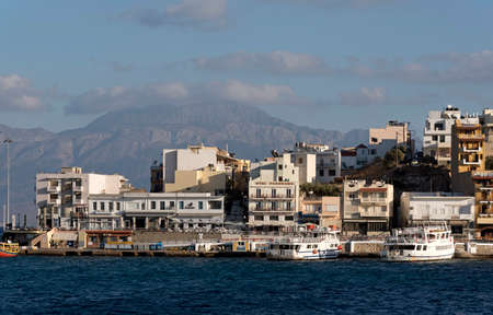 Agios Nikolaos, Crete, Greece. The seafront harbour area seen in evening light. October 2017のeditorial素材
