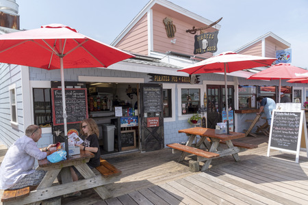 Johns Pass Village, Florida USA, Couple eating lunch on the boardwalk.のeditorial素材