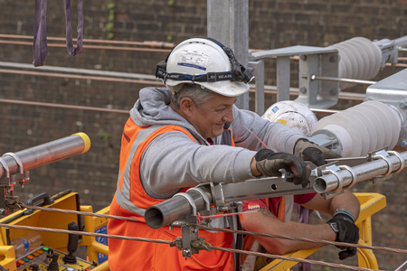 Newbury Station, Berkshire UK. Engineers working on the electrification  of the railway line at...