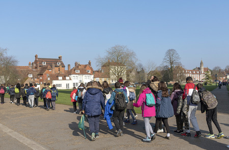 Salisbury, Wiltshire, England, UK. February 2019. Visiting students on Cathedral Close within the...