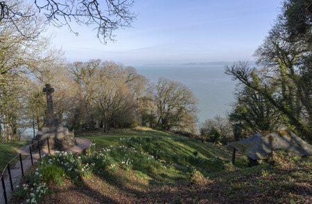 Clovelly, North Devon, England, UK. February 2019. A war memorial and Spring flowers at a picnic spot called Mount Pleasant with coastal views.のeditorial素材