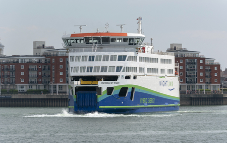 Portsmouth, England, UK. May 2019. The roro ferry Victoria of Wight with a backdrop of residential properties of Gunwharf Quays Portsmouth Harbourのeditorial素材