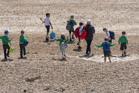 Southsea, Portsmouth, England, UK. May 2019 Group of school children on the shingle beach at Southsea an English resort.のeditorial素材