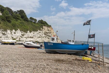 Beer near Seaton, Devon, England, UK. Beer beach on the Jurassic Coast in East Devon. Fishing boats and white calk cliffs.のeditorial素材