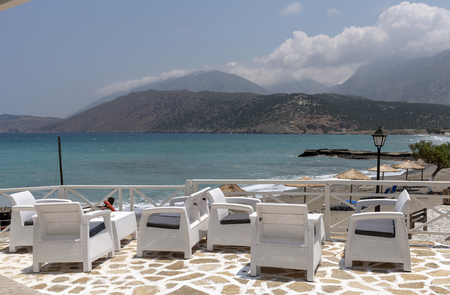 Pachia Ammos, Crete, Greece. June 2019. Restaurant bar area overlooking the beach and sea at this small resort.のeditorial素材