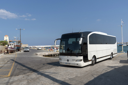 Ierapetra, Crete, Greece. June 2019. Tourist coach waiting in the harbour area of this Cretan town, Ierepetra southern Crete.のeditorial素材