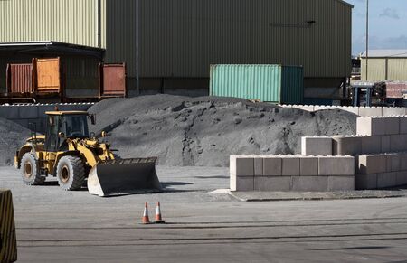 Port of Poole, southern England, UK. September 2019.  Tractor moving imported industrial materials on the dockside.のeditorial素材