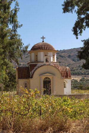 Kastelli, Crete, Greece. October 2019. The church of Agios Nektarios surrounded with vines at Kastelli, eastern Creteのeditorial素材