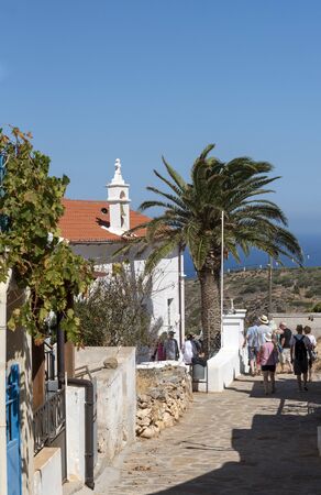 Kato Seles, northern Crete, Greece. October 2019.  Tourist group exploring a narrow lane in Kato Seles town centre.のeditorial素材